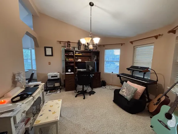 a room with furniture and musical instruments