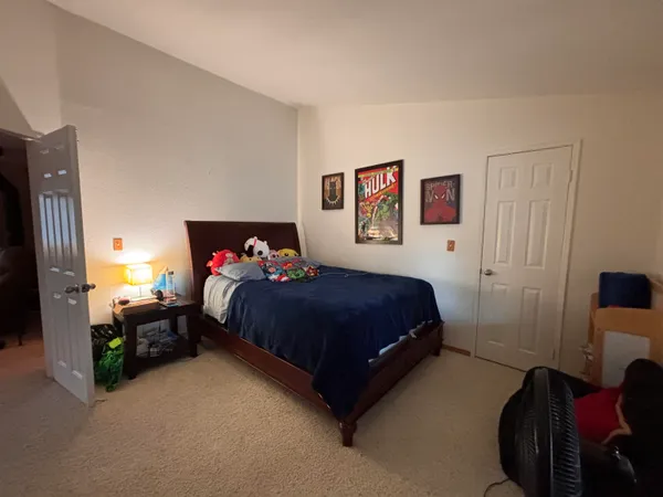 a bedroom with a bed and a view of bedroom