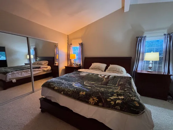 a bedroom with a bed and window