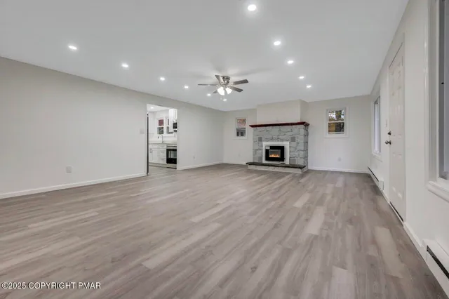 a large kitchen with stainless steel appliances kitchen island granite countertop a sink and cabinets