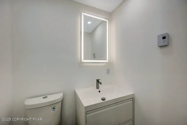 a spacious bedroom with a bed and a painting on the wall