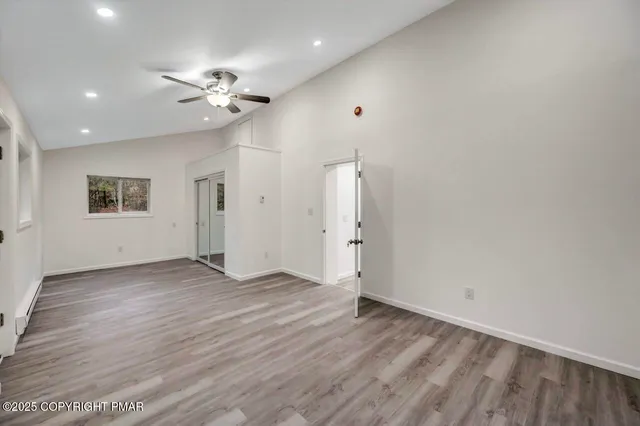 a view of a room with wooden floors and stairs