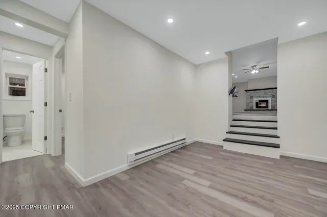 a view of an empty room with wooden floor