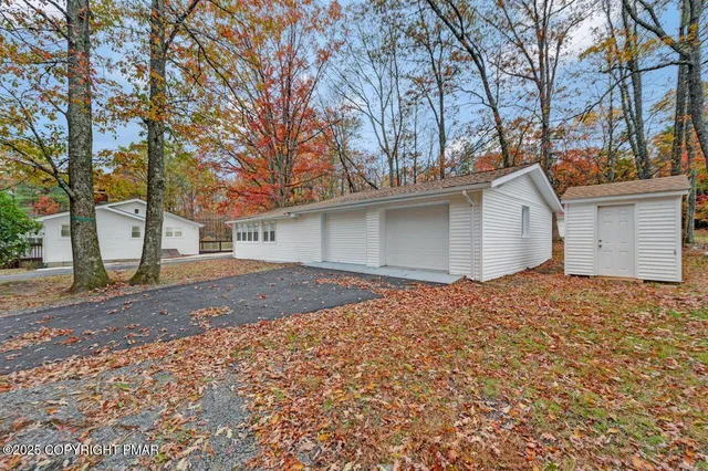 an empty room with windows and a fireplace