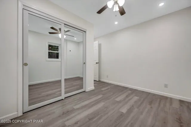 a front view of a house with a yard and tree