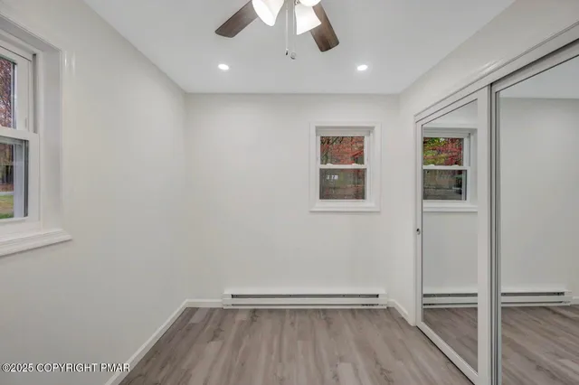 a backyard of a house with large trees and garage