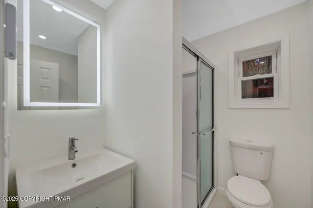 a view of a house with a yard and large trees