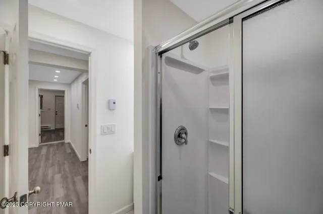 a view of backyard of house with outdoor seating and covered with trees