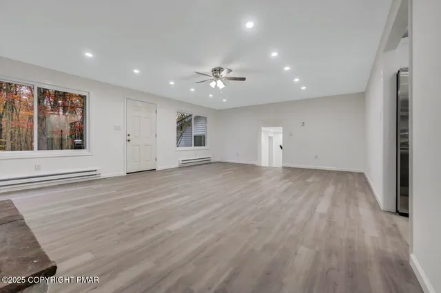 a kitchen with stainless steel appliances cabinets and wooden floor