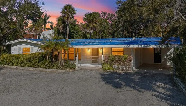 a view of a house with wooden fence