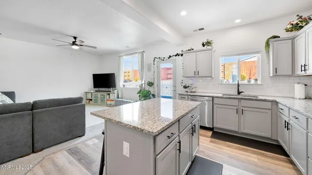 a kitchen with granite countertop a sink stove and cabinets