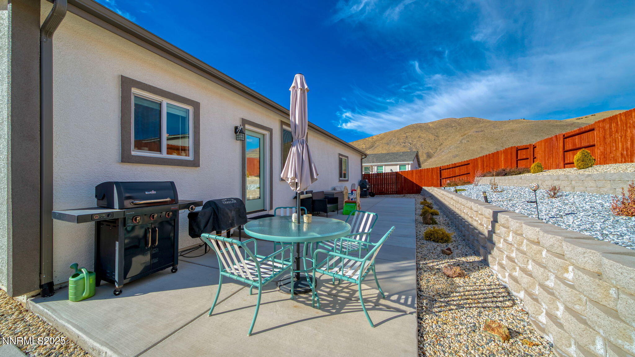 17821 Rose Meadow Court Reno, NV 89508 - Photo 34 of 39 a view of a patio with table and chairs and potted plants