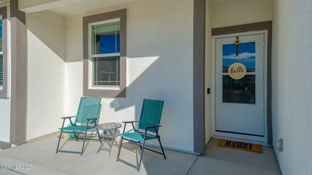 a view of an entryway with table and chair