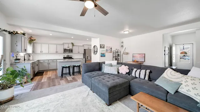 a living room with furniture and kitchen view