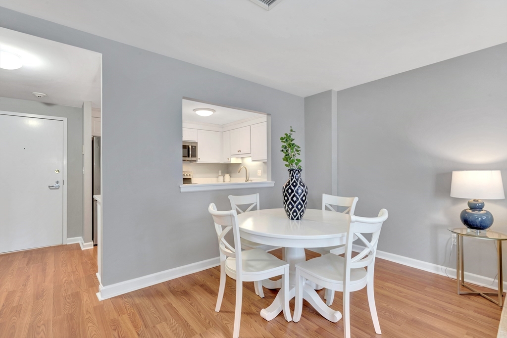 1 Watermill Place, Unit 312 Arlington, MA 02476 - Photo 12 of 33 a view of a dining room with furniture and wooden floor