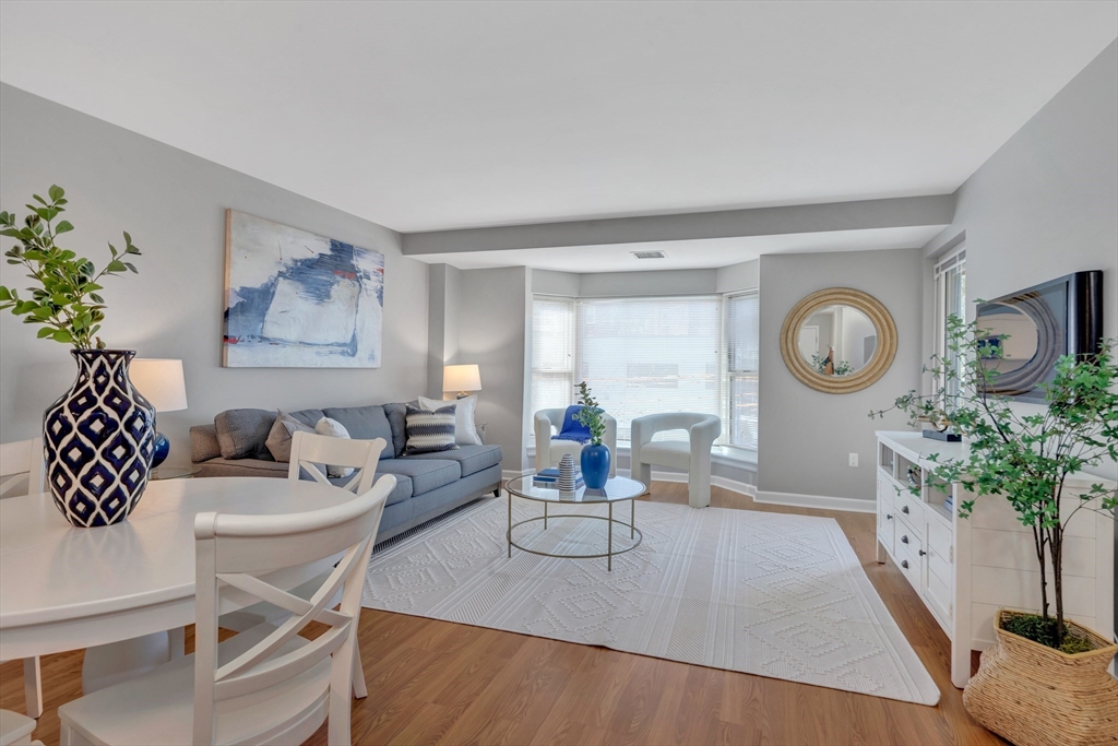 1 Watermill Place, Unit 312 Arlington, MA 02476 - Photo 2 of 33 a living room with furniture a clock and a window