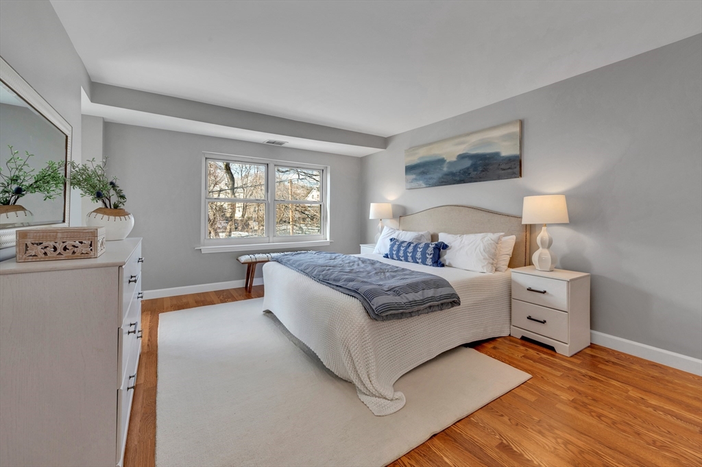 1 Watermill Place, Unit 312 Arlington, MA 02476 - Photo 21 of 33 a bedroom with a bed and a night stand