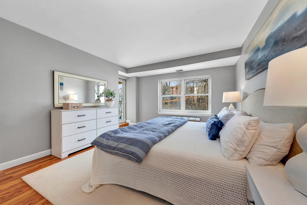 1 Watermill Place, Unit 312 Arlington, MA 02476 - Photo 22 of 33 a bedroom with a large bed and a window