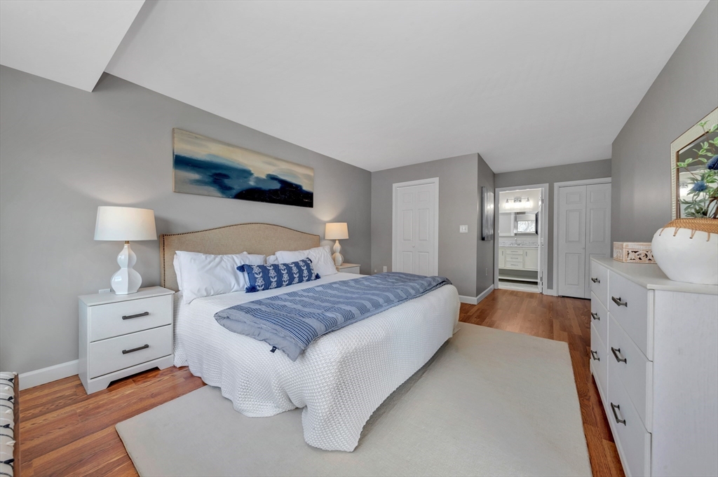 1 Watermill Place, Unit 312 Arlington, MA 02476 - Photo 23 of 33 a spacious bedroom with a bed and a lamp