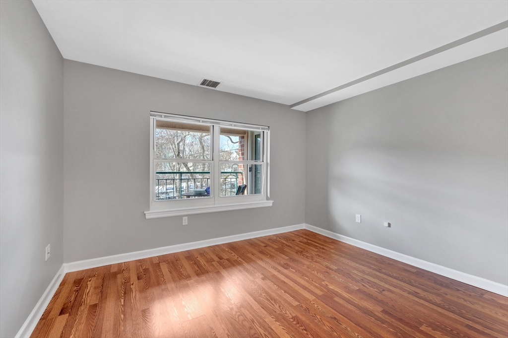 1 Watermill Place, Unit 312 Arlington, MA 02476 - Photo 24 of 33 an empty room with wooden floor and windows