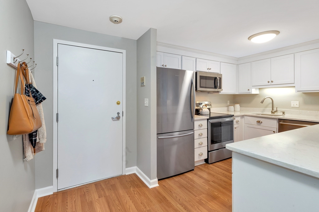 1 Watermill Place, Unit 312 Arlington, MA 02476 - Photo 4 of 33 a kitchen with a refrigerator and a sink