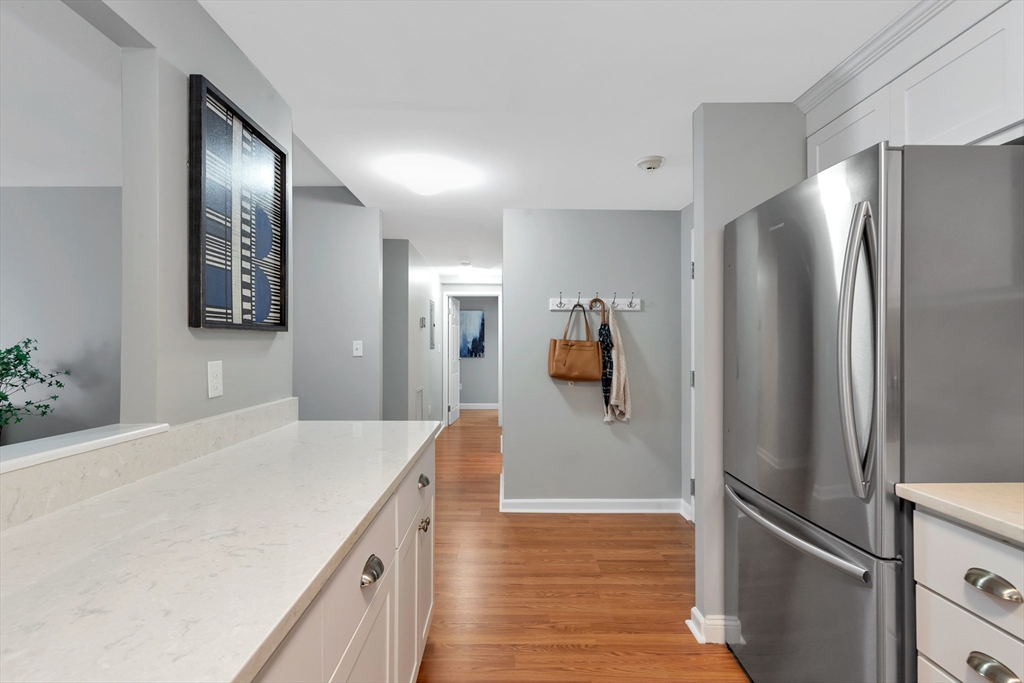1 Watermill Place, Unit 312 Arlington, MA 02476 - Photo 8 of 33 a kitchen with a refrigerator and countertop