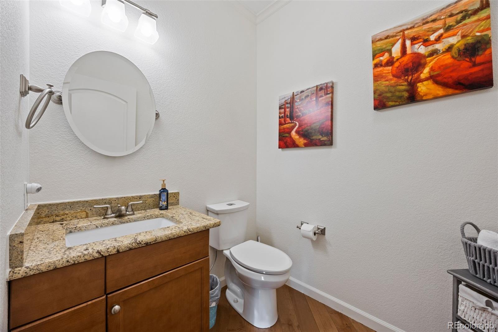 8558 Gold Peak Lane, Unit B Highlands Ranch, CO 80130 - Photo 13 of 41 a bathroom with a toilet a sink and mirror