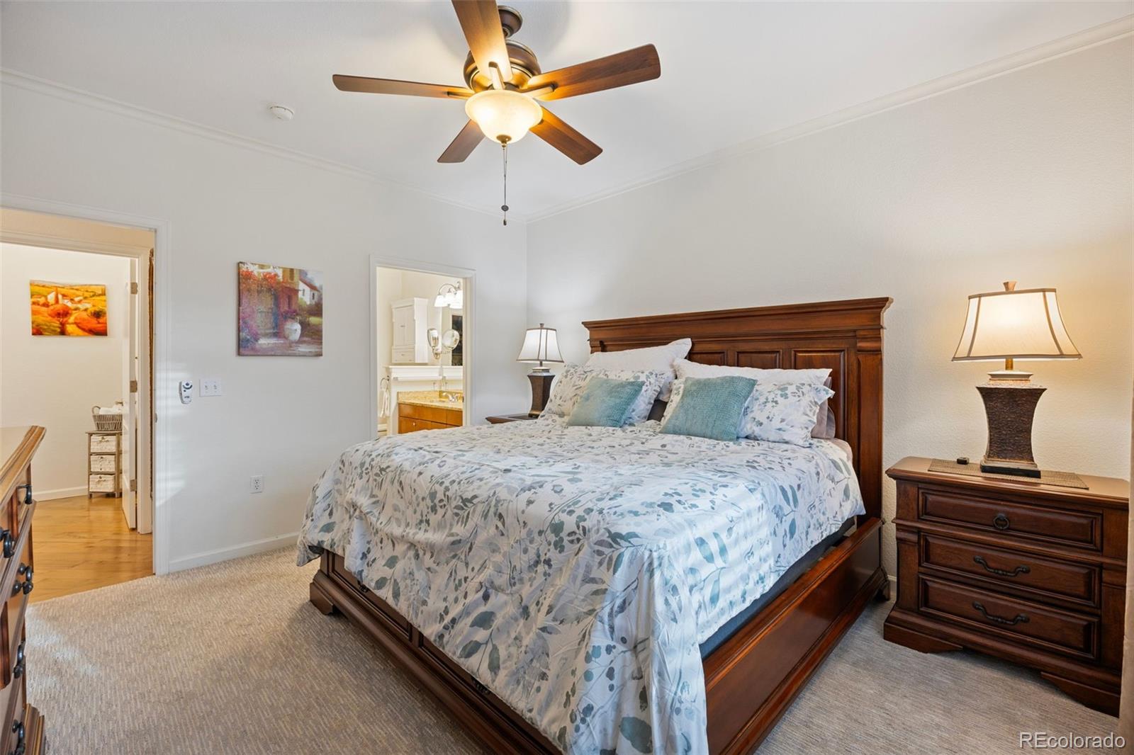 8558 Gold Peak Lane, Unit B Highlands Ranch, CO 80130 - Photo 15 of 41 a bedroom with a bed and a chandelier