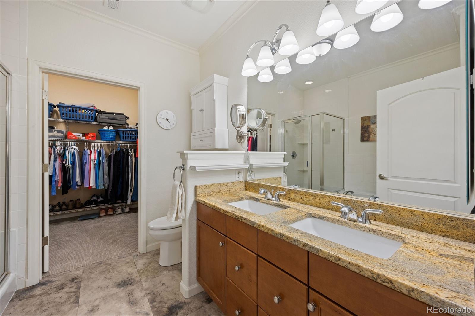 8558 Gold Peak Lane, Unit B Highlands Ranch, CO 80130 - Photo 16 of 41 a spacious bathroom with a granite countertop sink a toilet and a mirror