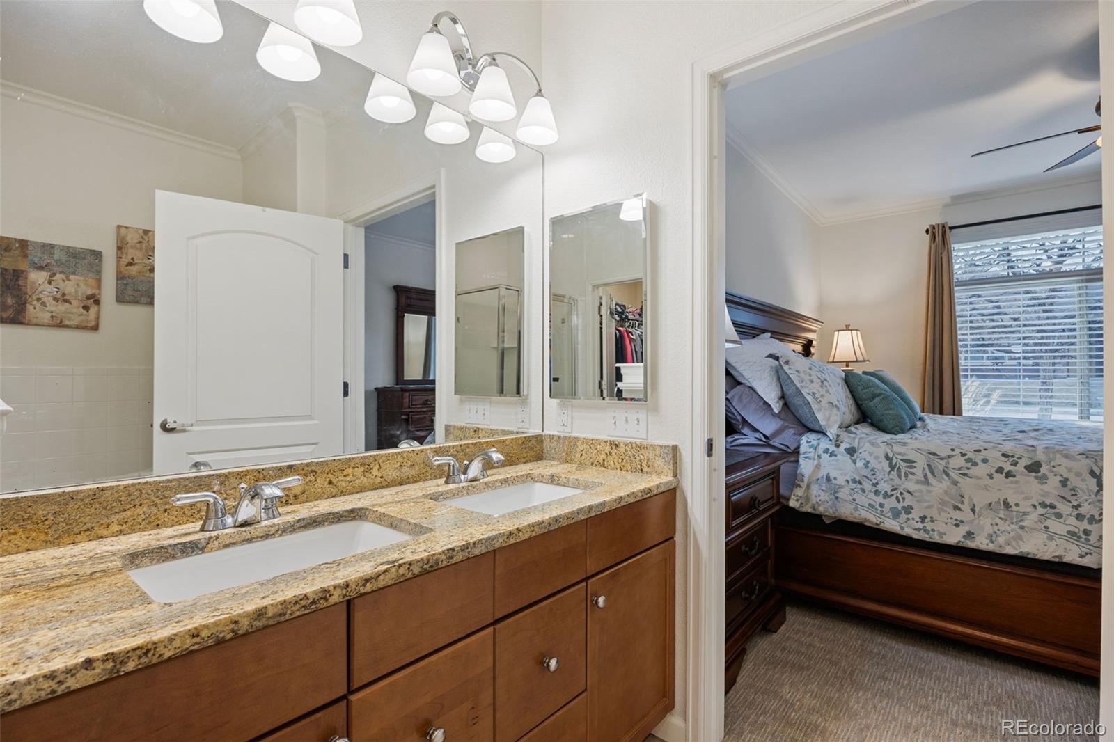 8558 Gold Peak Lane, Unit B Highlands Ranch, CO 80130 - Photo 17 of 41 a spacious bedroom with a bed and a dresser