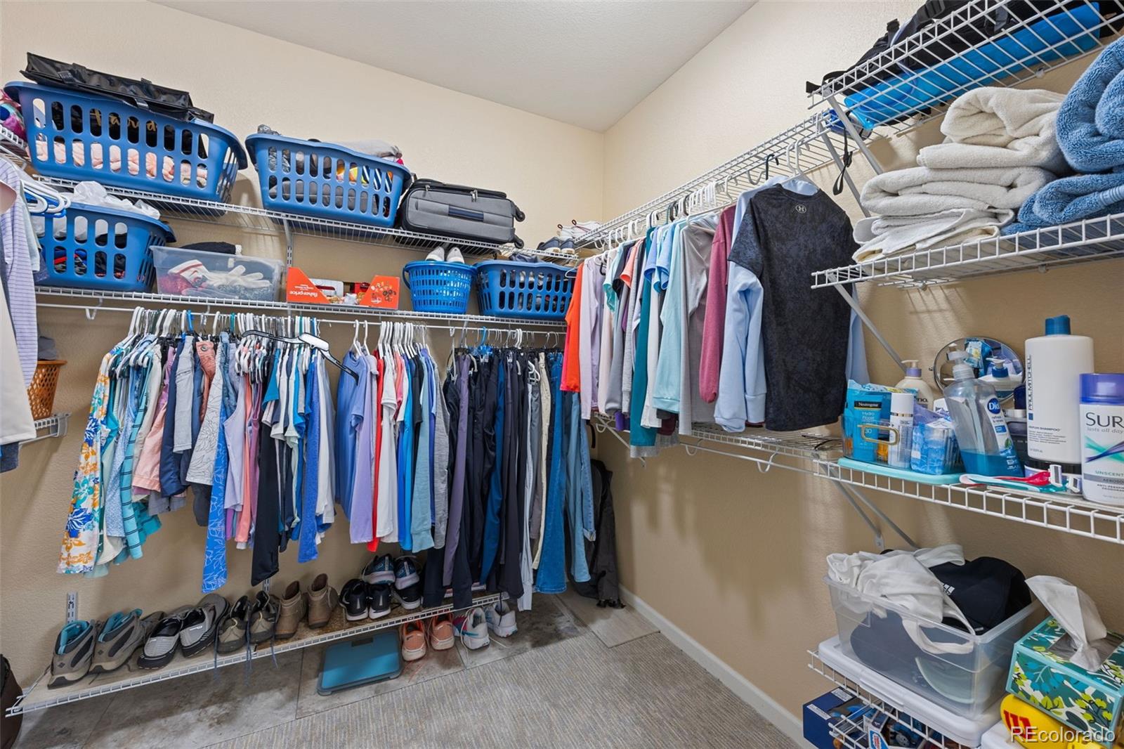 8558 Gold Peak Lane, Unit B Highlands Ranch, CO 80130 - Photo 18 of 41 a view of walk in closet with clothes and shoes