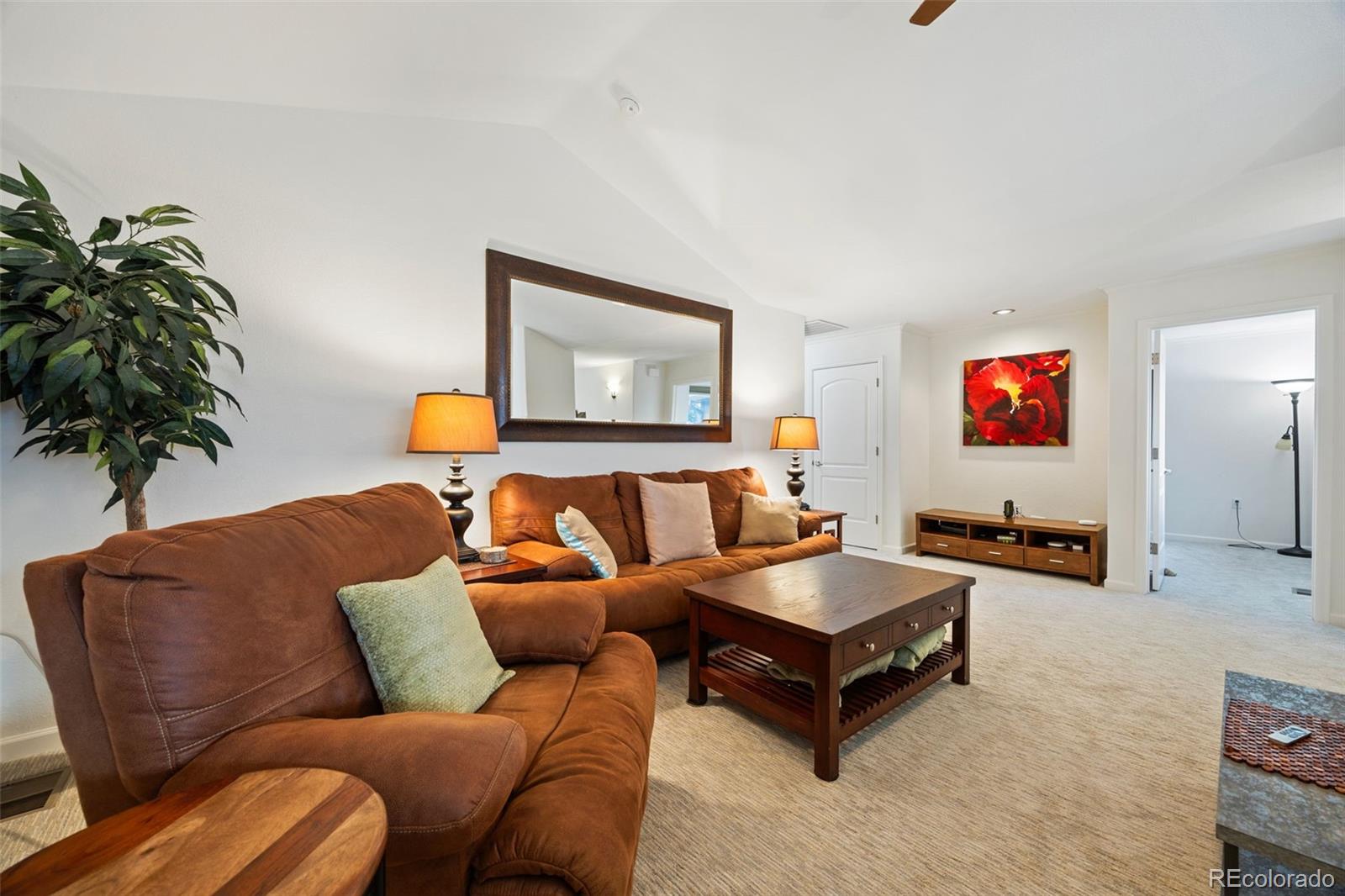 8558 Gold Peak Lane, Unit B Highlands Ranch, CO 80130 - Photo 22 of 41 a living room with furniture and a potted plant