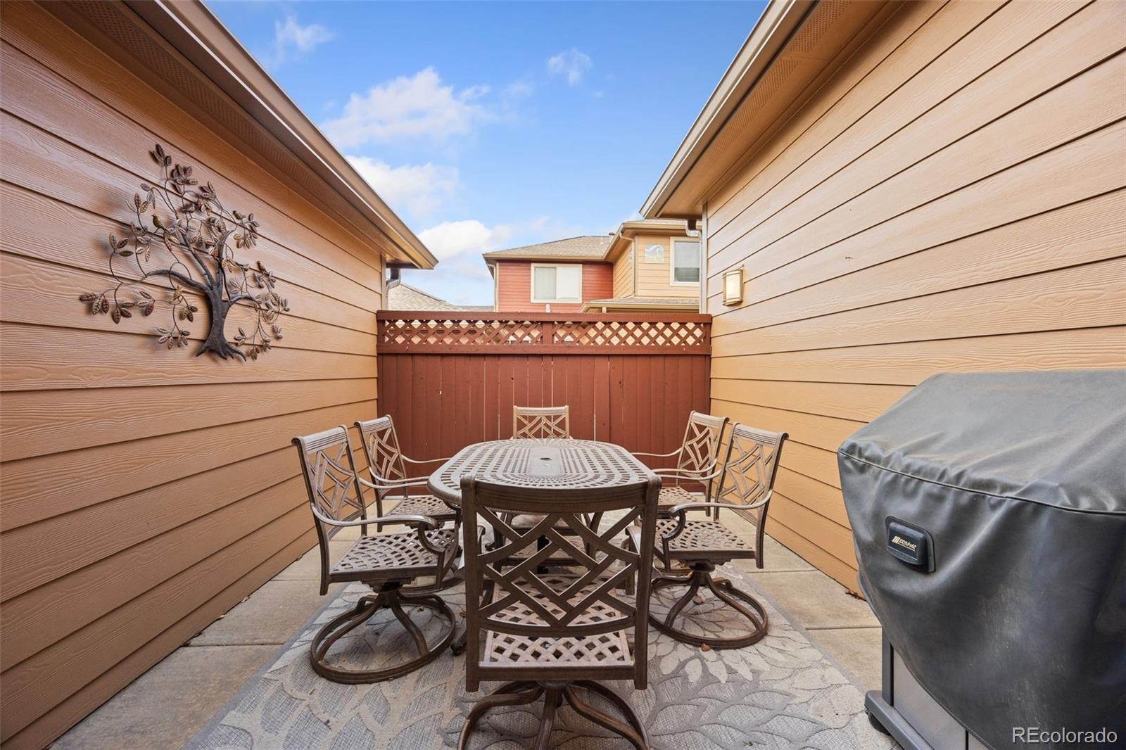 8558 Gold Peak Lane, Unit B Highlands Ranch, CO 80130 - Photo 29 of 41 a view of a table and chairs in patio