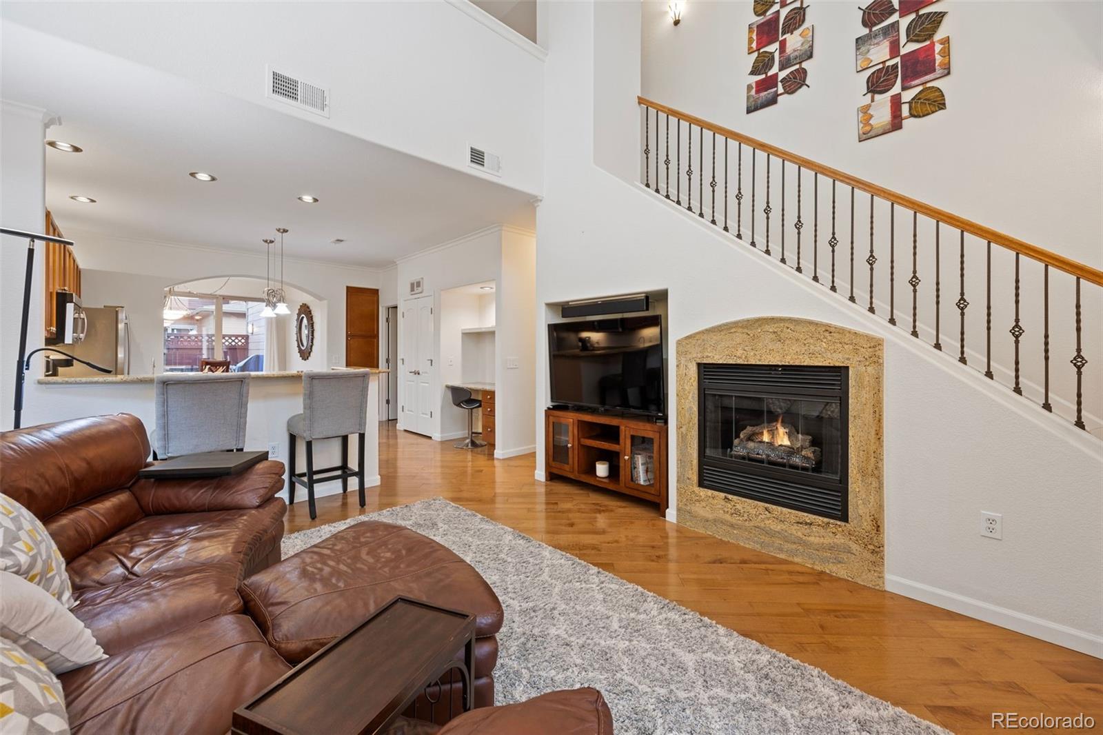 8558 Gold Peak Lane, Unit B Highlands Ranch, CO 80130 - Photo 8 of 41 a living room with furniture and a fireplace