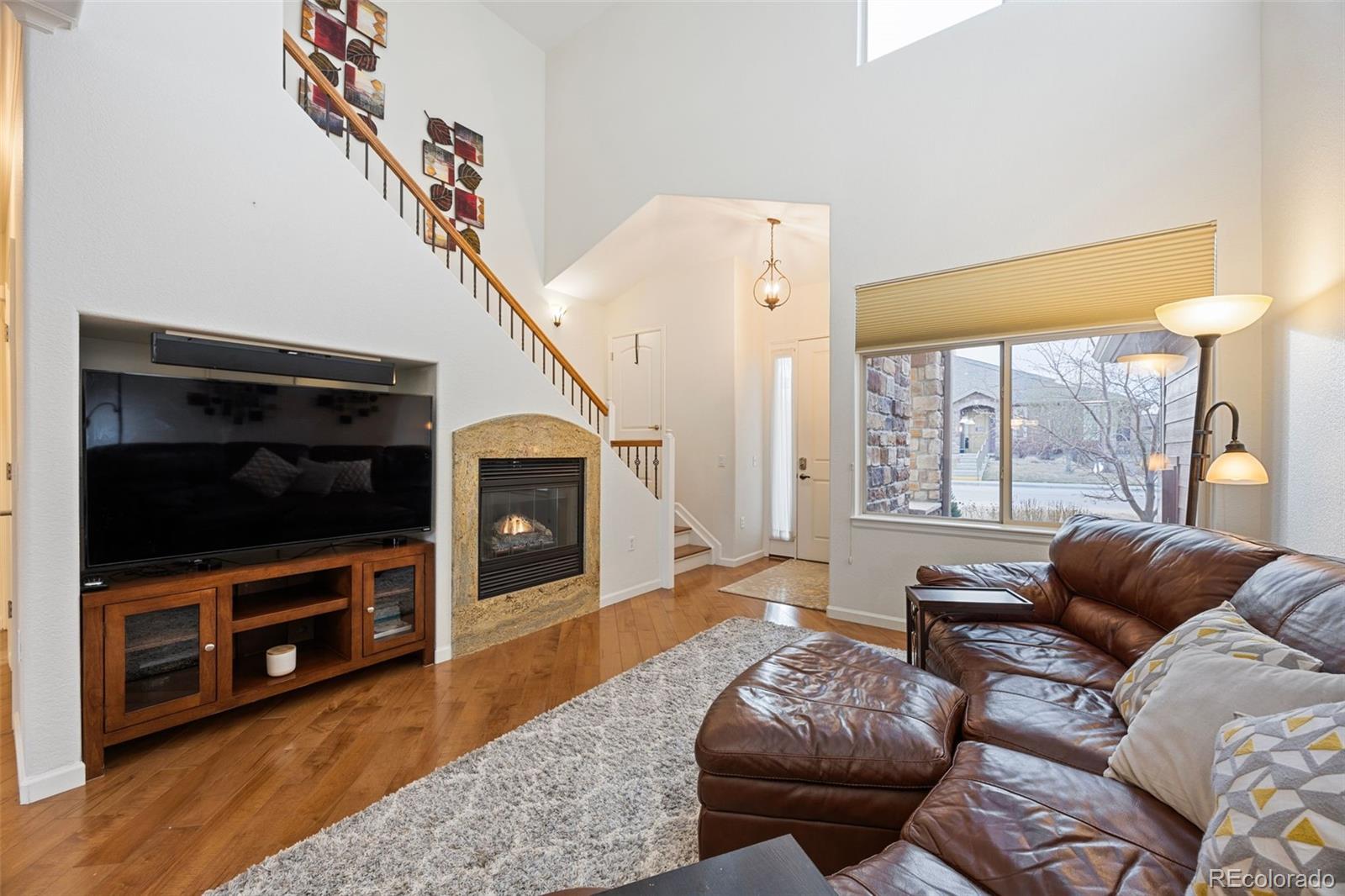 8558 Gold Peak Lane, Unit B Highlands Ranch, CO 80130 - Photo 9 of 41 a living room with furniture and a flat screen tv