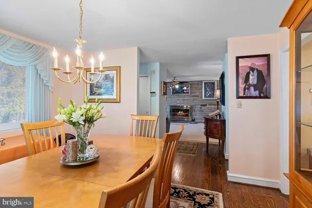 a dining room with furniture and chandelier