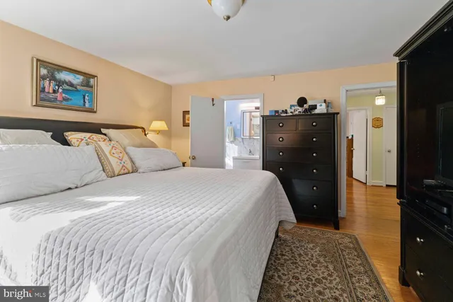 a bedroom with a bed and a television