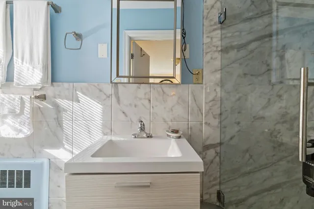 a bathroom with a sink a mirror and vanity