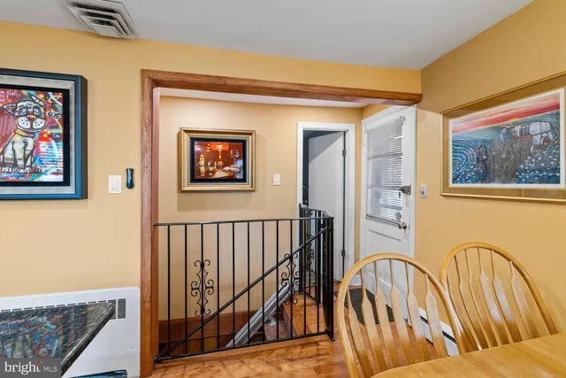 a view of a hallway with wooden floor and windows