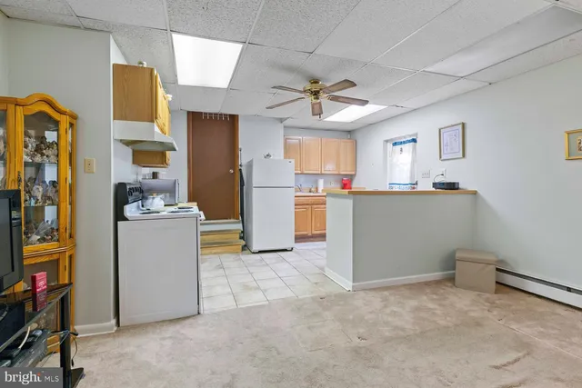 a view of kitchen with refrigerator and window