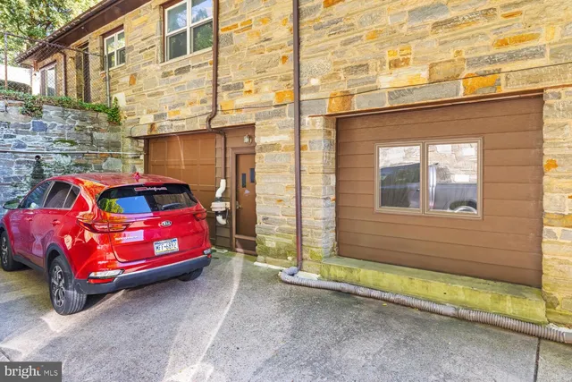a front view of a house with parking area