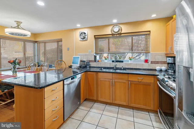 a kitchen with stainless steel appliances granite countertop sink stove and cabinets