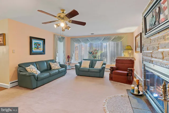 a living room with furniture and a ceiling fan