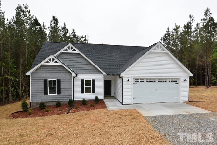 811 Ned Moore Road Timberlake, NC 27583 - Photo 2 of 33 a view of a house with a backyard