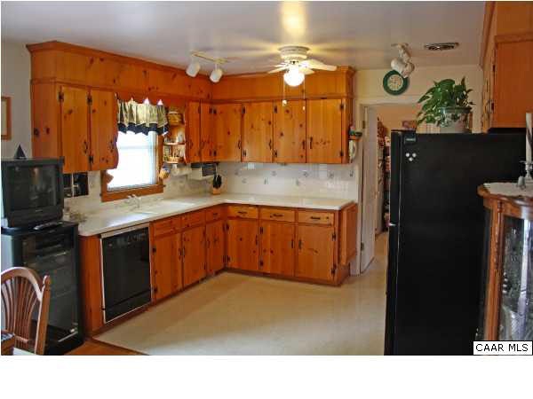 182 Childs Road Stanardsville, VA 22973 - Photo 8 of 27 a kitchen with stainless steel appliances kitchen island granite countertop a refrigerator
