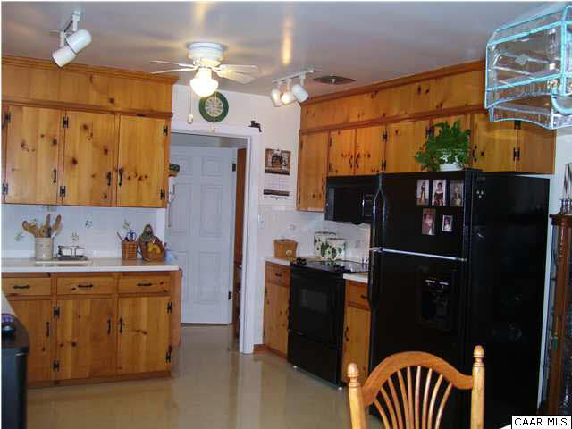 182 Childs Road Stanardsville, VA 22973 - Photo 10 of 27 a kitchen with a refrigerator and a stove top oven