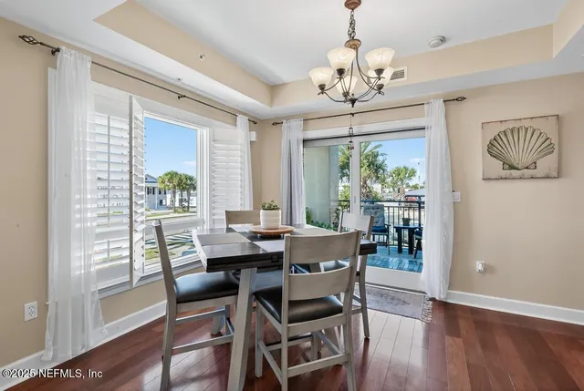 a view of a patio with a table and chairs under an umbrella