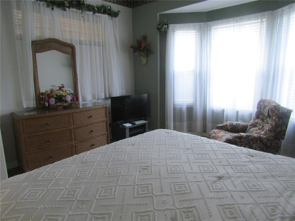 4137 Bella Pasque Venice, FL 34293 - Photo 15 of 30 a bedroom with a bed and a dresser