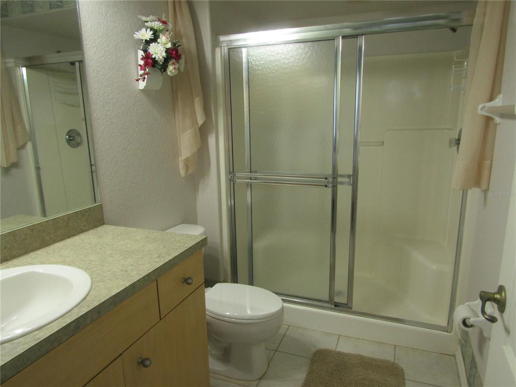 4137 Bella Pasque Venice, FL 34293 - Photo 16 of 30 a bathroom with a granite countertop sink toilet and shower