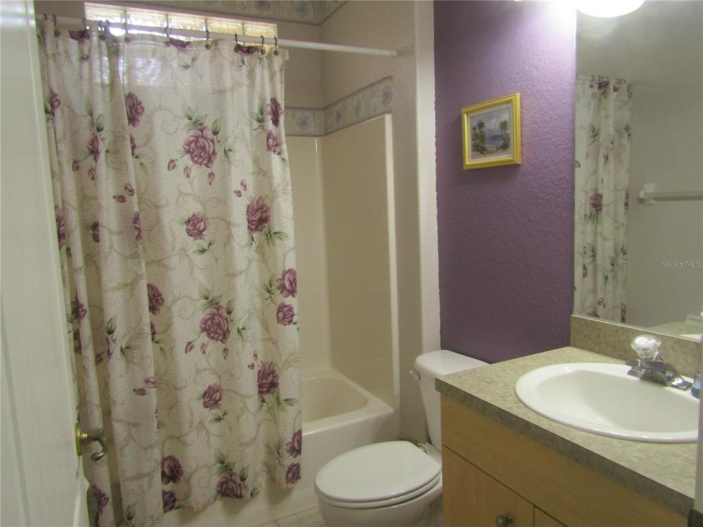 4137 Bella Pasque Venice, FL 34293 - Photo 20 of 30 a bathroom with a granite countertop sink toilet and shower